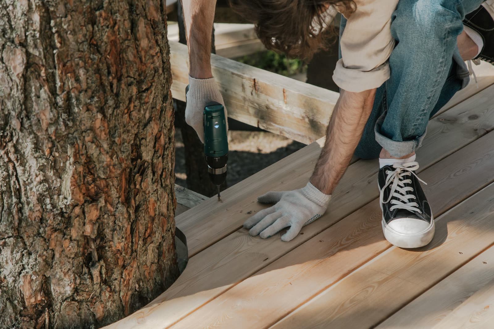 Builder securing deck boards on a dock frame